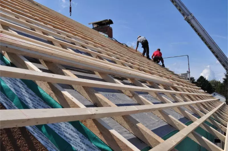 All Around Solutions builders working on an open rooftop